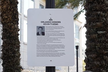 A sign that features a photo of Kevin Tyjeski and information about his life.
