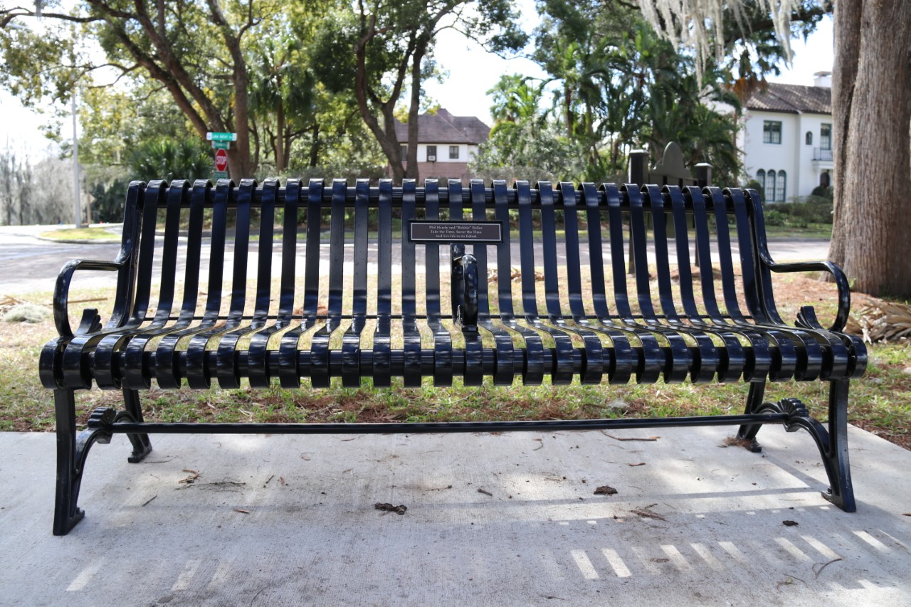 An example of a memorial bench at a city park, with a commemoration plaque for a customized message.