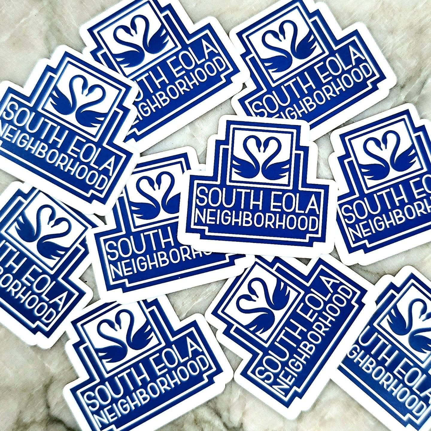 Blue and white stickers labeled with South Eola Neighborhood's branding