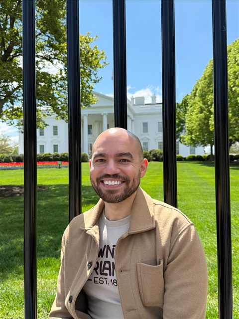 Felix Roman standing in front of the White House fence