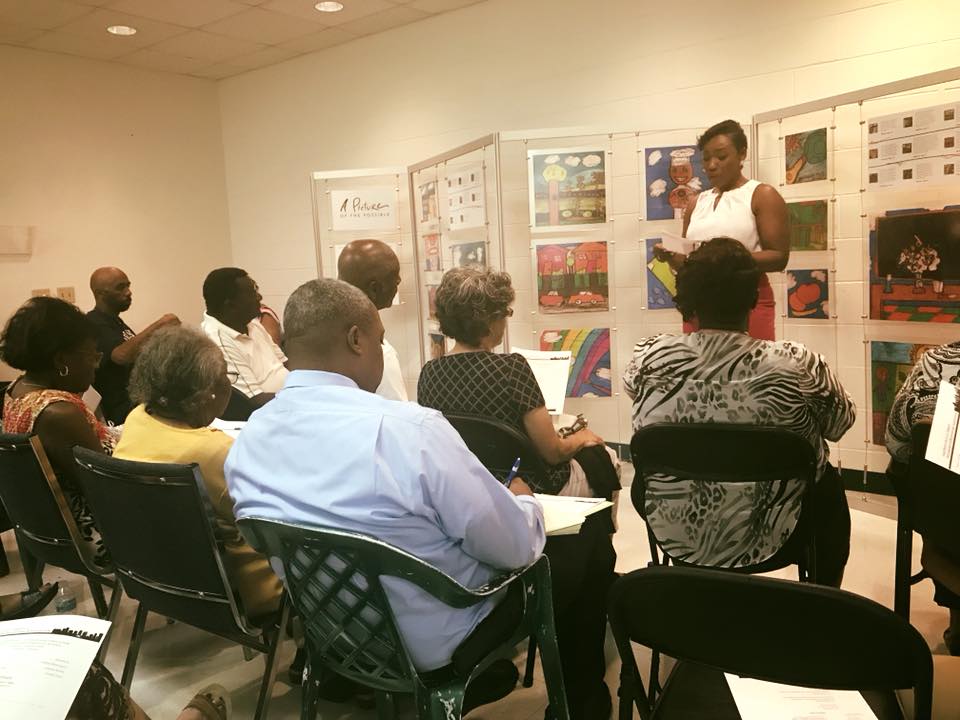 Neighborhood leaders listening to an outreach coordinator