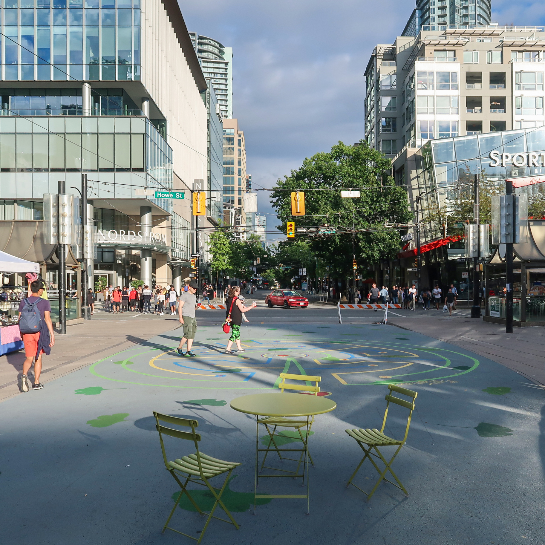 A photo of a street that has been converted to pedestrian space with street furniture and artistic elements.